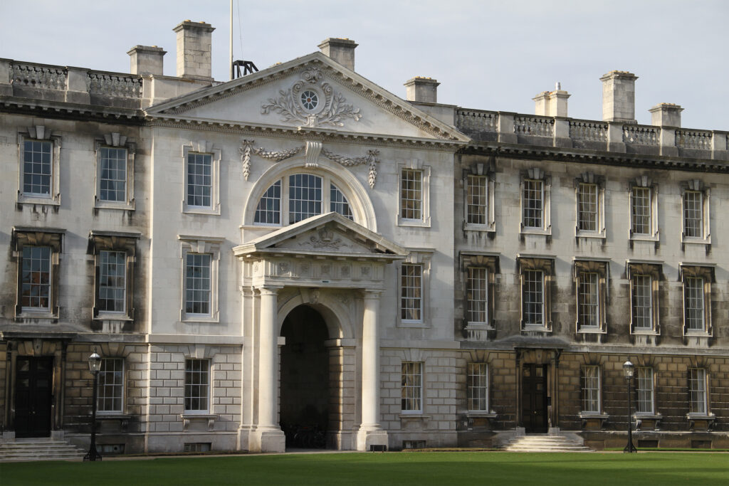 Styles Façade Solutions® documented the weathered Gibbs Building at King's College, Cambridge, prior to restoration. The Portland stone façade shows heavy grey-black staining and streaking across window surrounds, cornices, and the pedimented centrepiece, providing a baseline record ahead of the planned façade cleaning and conservation programme.