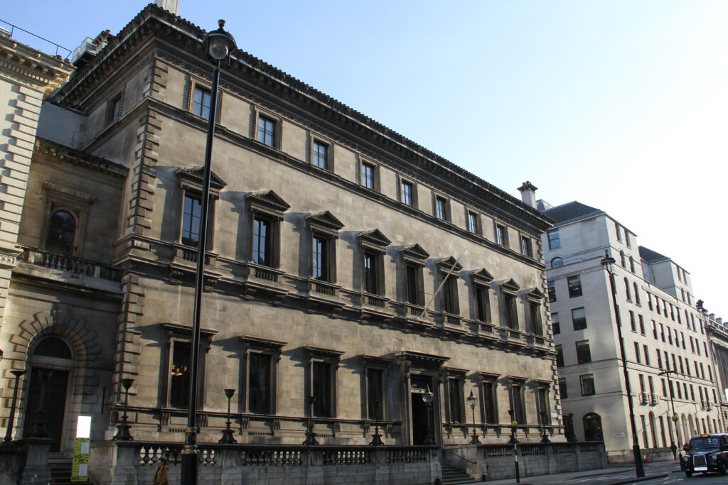 Styles Façade Solutions® prepares to clean the weathered stone façade of The Reform Club, London's Grade I listed Italianate landmark. This "before" image captures the building's grimy, darkened stonework and elegant classical detailing ahead of the planned façade cleaning work.