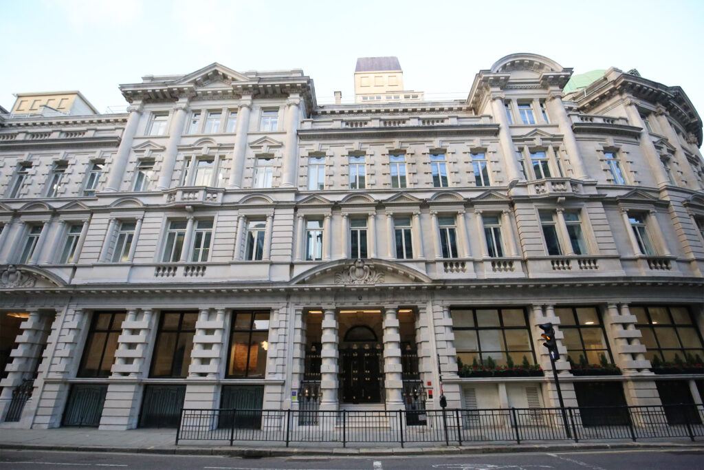 Styles Façade Solutions® reveals the fully restored classical stonework at 1-5 London Wall, London, following the Façade Gommage cleaning process, with the building's decorative columns, pediments, and ornate detailing now bright and uniform, showcasing the elegant façade's original architectural character.