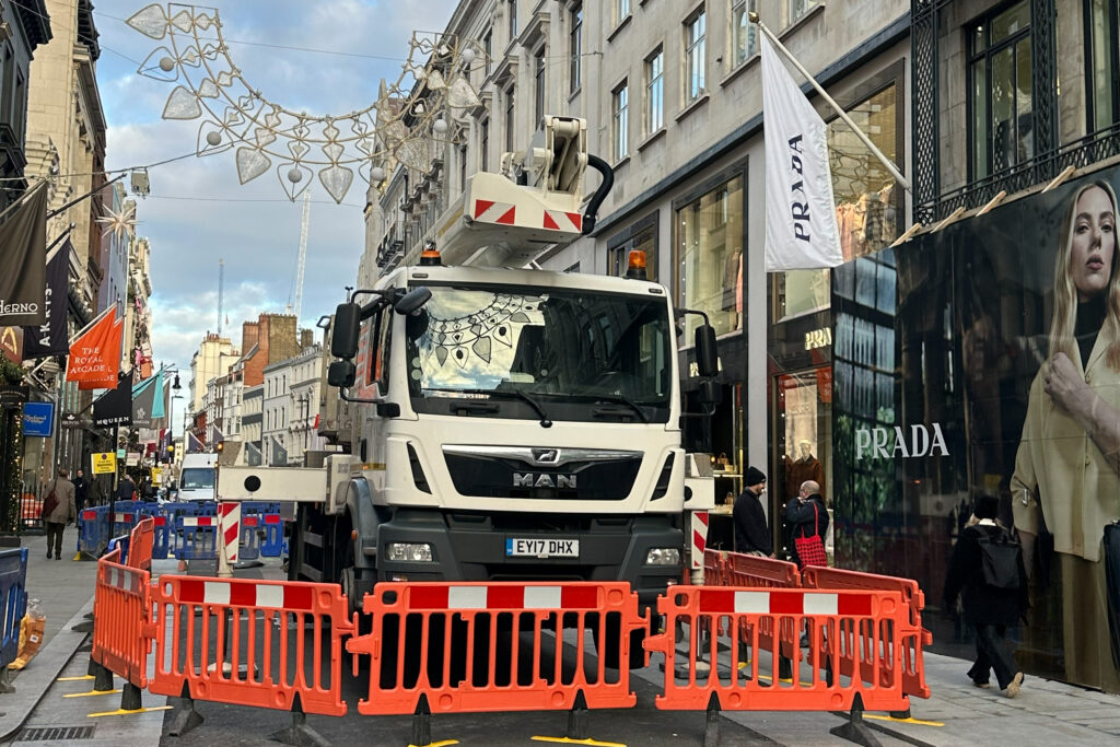 The Styles Façade Solutions® survey team set up a MWEP outside 16-18 Old Bond Street, London, to carry out a commercial façade survey. With safety barriers in place securing the work zone, the elevated platform allows close inspection of the building's upper stonework and architectural detailing.