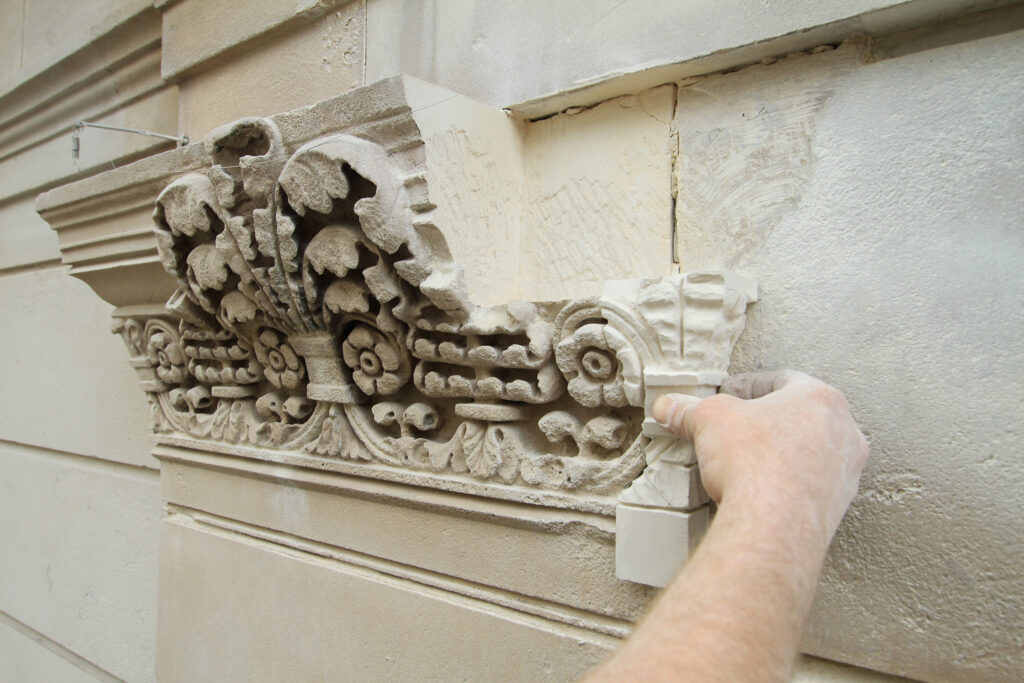 Styles Façade Solutions®' stonemason's hand-carved replacement section of ornate floral moulding being prepared to be installed on the Bank of England's historic Grade I listed Portland stone façade.