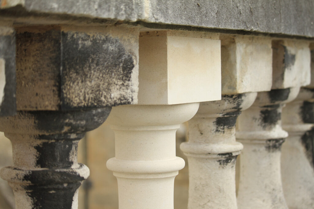 Styles Façade Solutions® hand-crafted this new Portland stone baluster to seamlessly replace a damaged original within the historic balustrade. Set against neighbouring weathered and soiled balusters, the sharp detailing demonstrates the stonemason's skilled traditional craftsmanship in matching profile, proportion, and finish.