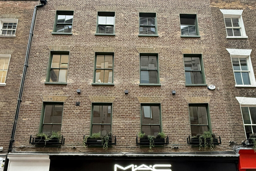 Styles Façade Solutions® completed the full façade restoration of 46 Carnaby Street, London, stripping all paint to reveal the original Victorian brickwork, repointing mortar joints, restoring decorative gauged brick arches, and repainting all timber sash window surrounds.