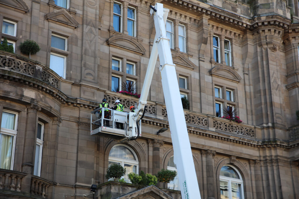 The surveying team from Styles Façade Solutions (formerly Thomann-Hanry®) using a MEWP to undertake a commercial building façade survey, inspecting masonry and exterior stonework as part of a building condition survey for The Balmoral Hotel, Edinburgh.
