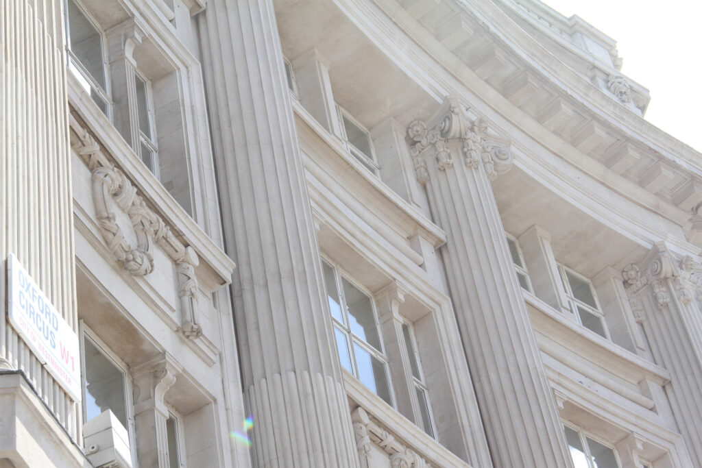 Styles Façade Solutions® highlights an ornate Portland stone façade at London's Oxford Circus. The fluted Corinthian pilasters, carved capitals and classical detailing showcase the timeless elegance of Portland stone.