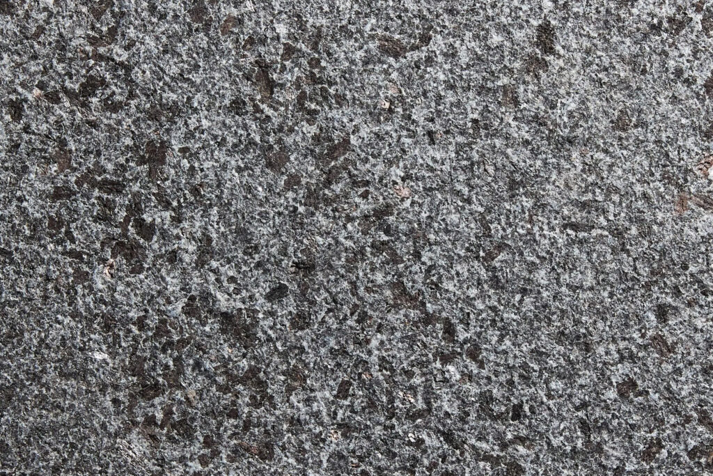 Styles Façade Solutions® showcases granite, one of the toughest and most durable façade materials available. Its densely speckled grey and charcoal crystalline texture creates a sleek, sophisticated finish, ideal for commercial buildings seeking a low-maintenance, striking natural stone appearance that withstands the elements.