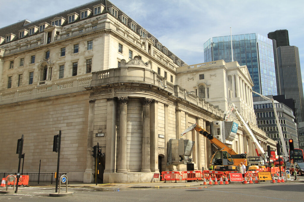 Styles Façade Solutions® undertaking sensitive heritage cleaning and restoration of the Grade I listed Bank of England's historic Portland stone façade. Careful conservation techniques, supported by crane access, protect the building's Neoclassical detailing and architectural heritage while preserving its character for future generations on this iconic City of London corner.